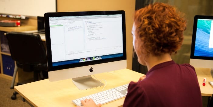 Programmer_writing_code_with_Unit_Tests